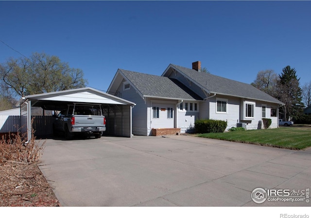 230 Beattie St, Sterling, CO 80751 - ranch-style home featuring a chimney, concrete driveway, fence, central air condition unit, and a front lawn