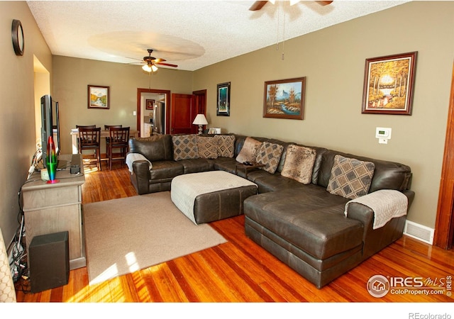 230 Beattie St, Sterling, CO 80751 - living area with ceiling fan, a textured ceiling, visible vents, wood finished floors, and baseboards
