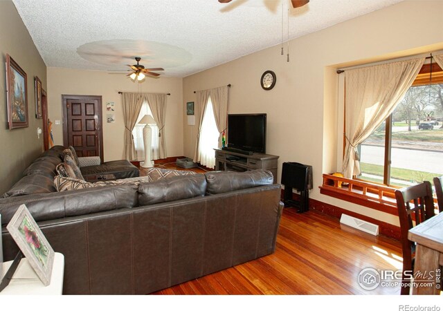 230 Beattie St, Sterling, CO 80751 - living area with ceiling fan, a textured ceiling, visible vents, wood finished floors, and baseboards