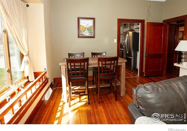 230 Beattie St, Sterling, CO 80751 - dining space with visible vents and wood finished floors