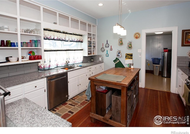 230 Beattie St, Sterling, CO 80751 - kitchen featuring dark wood-type flooring, white cabinetry, appliances with stainless steel finishes, a sink, and decorative backsplash