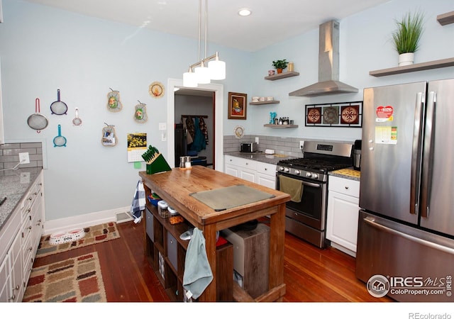 230 Beattie St, Sterling, CO 80751 - kitchen with dark wood-style flooring, wall chimney range hood, open shelves, white cabinets, and appliances with stainless steel finishes