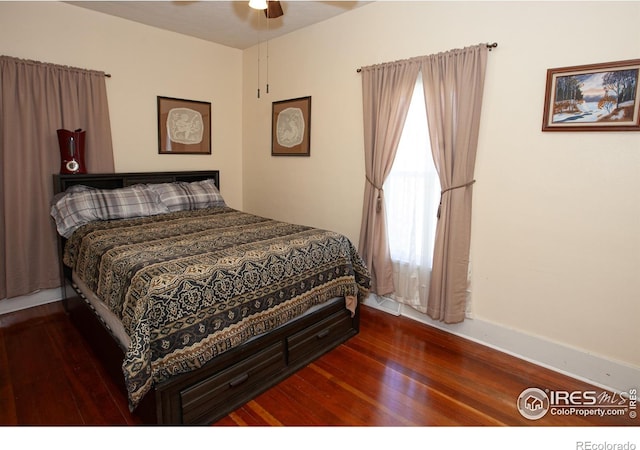 230 Beattie St, Sterling, CO 80751 - bedroom with baseboards, hardwood / wood-style floors, and a ceiling fan