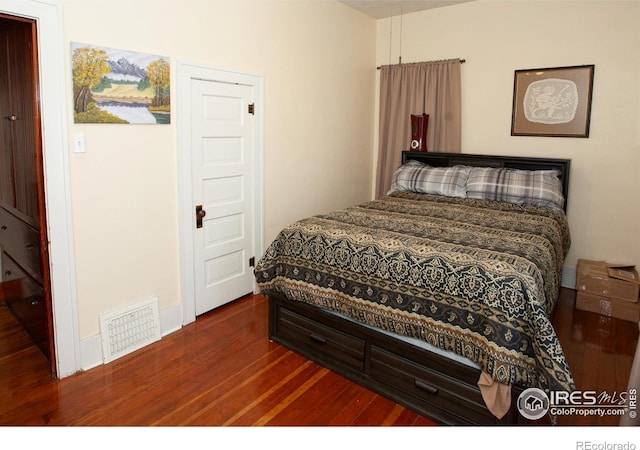 230 Beattie St, Sterling, CO 80751 - bedroom with visible vents and dark wood finished floors