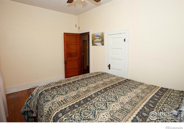 230 Beattie St, Sterling, CO 80751 - bedroom with wood finished floors, ceiling fan, and baseboards