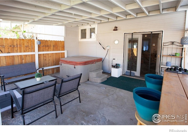 230 Beattie St, Sterling, CO 80751 - view of patio with fence and a hot tub