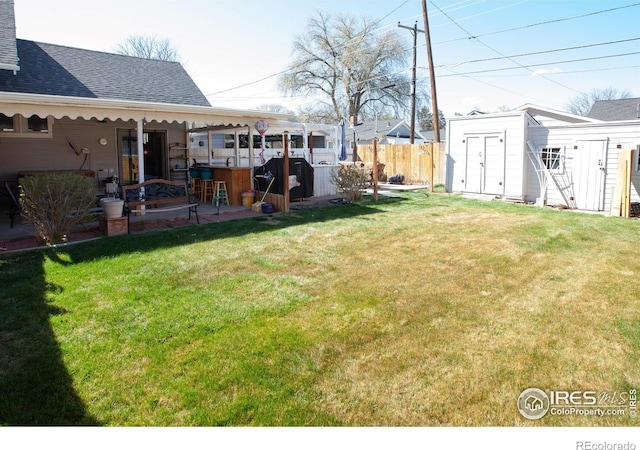 230 Beattie St, Sterling, CO 80751 - view of yard featuring a patio area, a storage shed, an outdoor structure, and fence