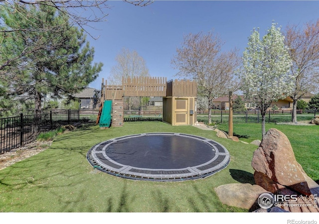 view of yard featuring fence and a trampoline