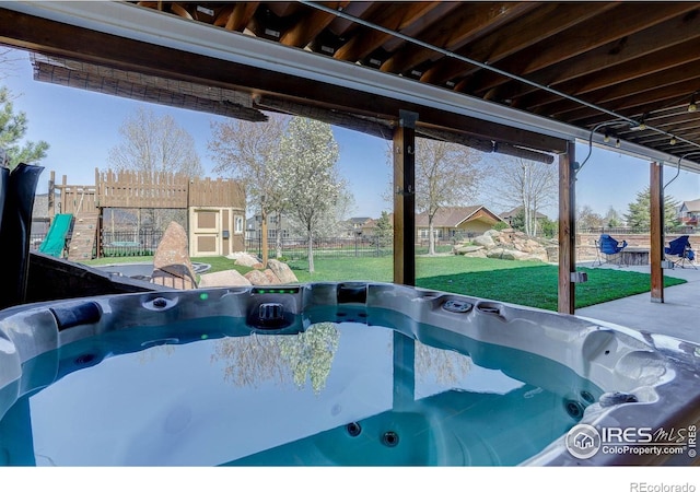 exterior space featuring a yard and a hot tub