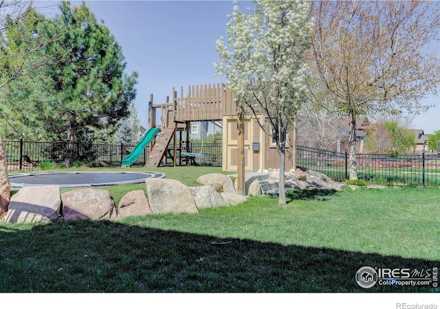 view of yard featuring fence and a playground
