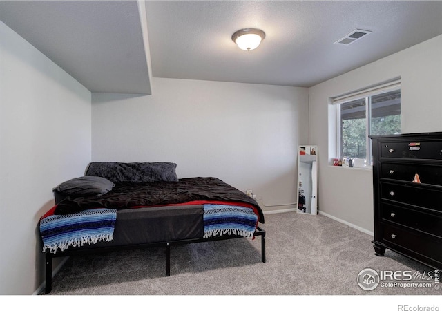 carpeted bedroom featuring visible vents and baseboards