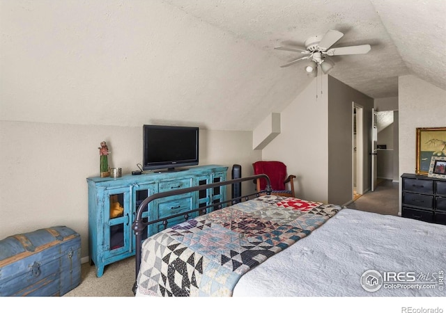 carpeted bedroom featuring baseboards, ceiling fan, vaulted ceiling, and a textured ceiling