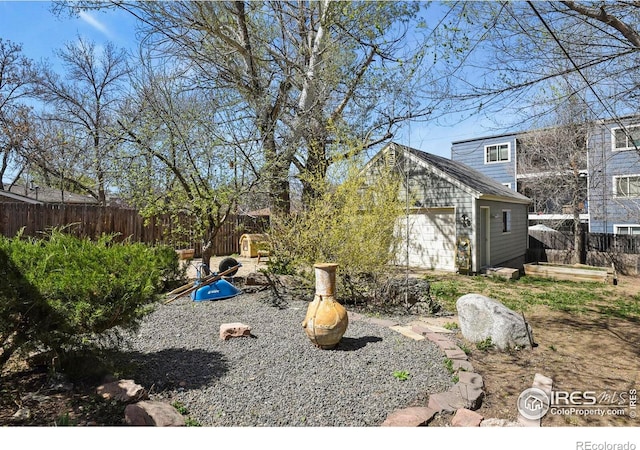 view of yard with a fenced backyard and an outdoor structure