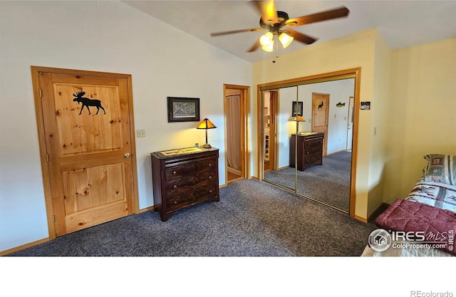 bedroom with a closet, ceiling fan, carpet flooring, and vaulted ceiling