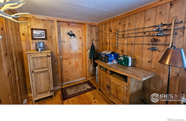 interior space featuring hardwood / wood-style floors and wood walls
