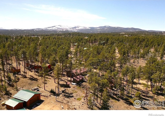 bird's eye view featuring a forest view and a mountain view