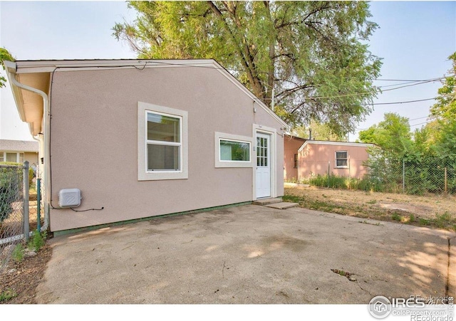 618 19th Ave, Greeley, CO 80631 - back of house featuring fence, a patio, and stucco siding