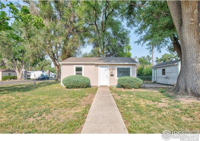 618 19th Ave, Greeley, CO 80631 - bungalow-style house featuring fence, an outbuilding, a front yard, and stucco siding