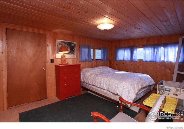 bedroom with wood walls and wood ceiling