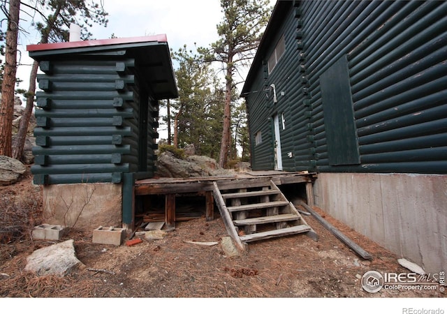 view of property exterior featuring log siding