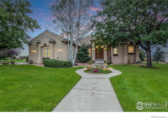 432 Valley View Rd, Loveland, CO 80537 - view of front facade featuring a front lawn and stucco siding