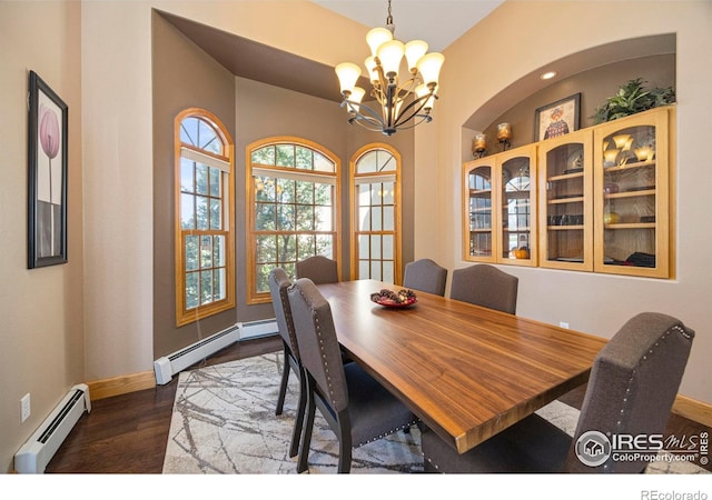 432 Valley View Rd, Loveland, CO 80537 - dining room featuring a baseboard heating unit, dark wood-style flooring, a notable chandelier, and baseboards