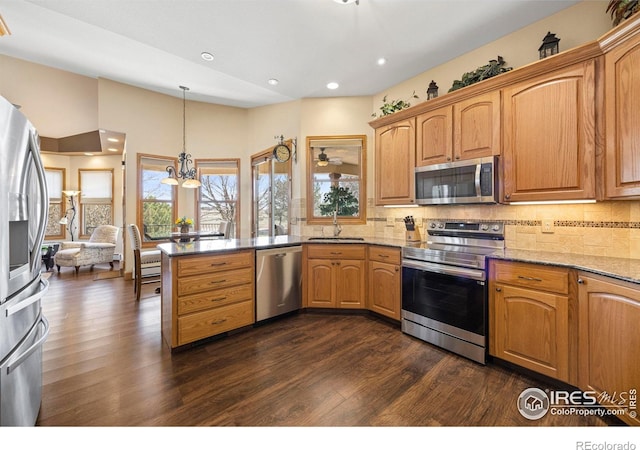 432 Valley View Rd, Loveland, CO 80537 - kitchen with a peninsula, light stone counters, appliances with stainless steel finishes, and plenty of natural light