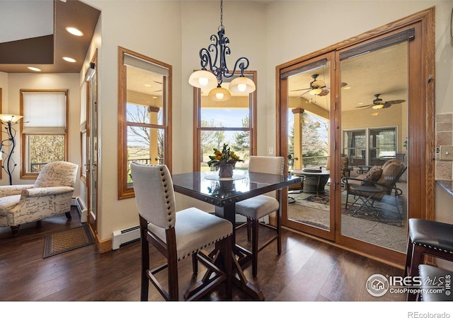 432 Valley View Rd, Loveland, CO 80537 - dining space featuring baseboard heating, a wealth of natural light, dark wood-style floors, and ceiling fan with notable chandelier