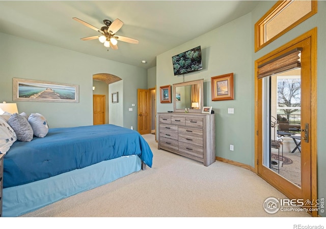 432 Valley View Rd, Loveland, CO 80537 - bedroom with arched walkways, access to exterior, baseboards, light colored carpet, and a ceiling fan