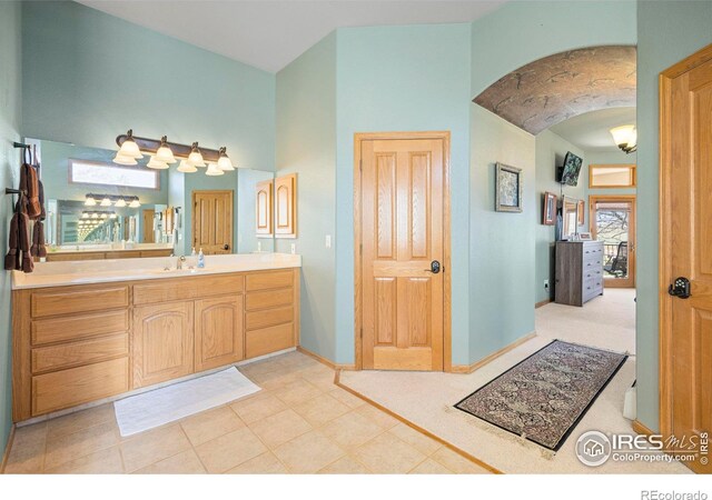 432 Valley View Rd, Loveland, CO 80537 - bathroom with vaulted ceiling, vanity, and baseboards