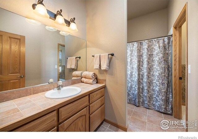 432 Valley View Rd, Loveland, CO 80537 - bathroom with tile patterned floors, vanity, and curtained shower