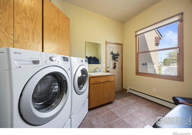 432 Valley View Rd, Loveland, CO 80537 - clothes washing area featuring a baseboard radiator, light tile patterned floors, cabinet space, and separate washer and dryer