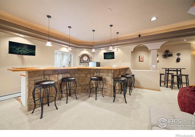 432 Valley View Rd, Loveland, CO 80537 - bar featuring light carpet, a tray ceiling, wet bar, baseboards, and pendant lighting