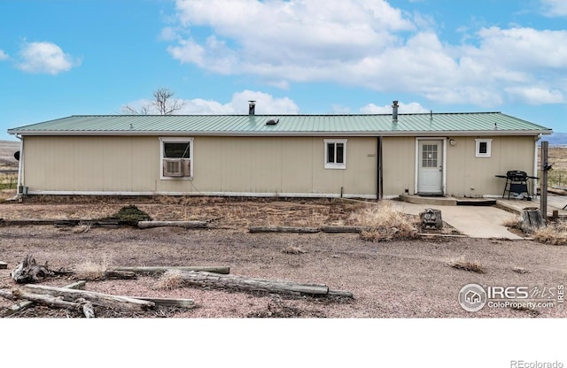 back of house featuring metal roof and a patio