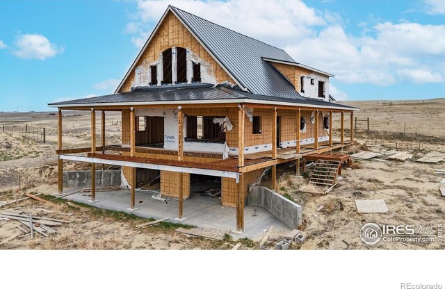 back of house featuring metal roof and a standing seam roof