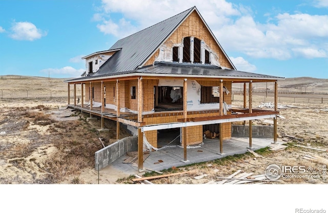 back of property featuring metal roof and a standing seam roof