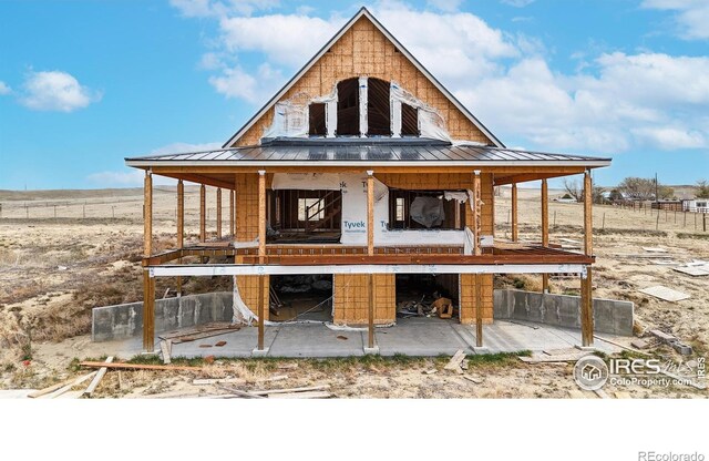 rear view of house with a standing seam roof and metal roof