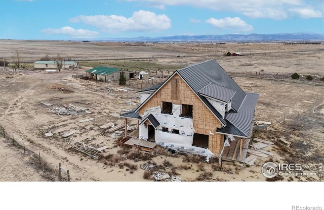 drone / aerial view featuring a rural view, a mountain view, and view of desert