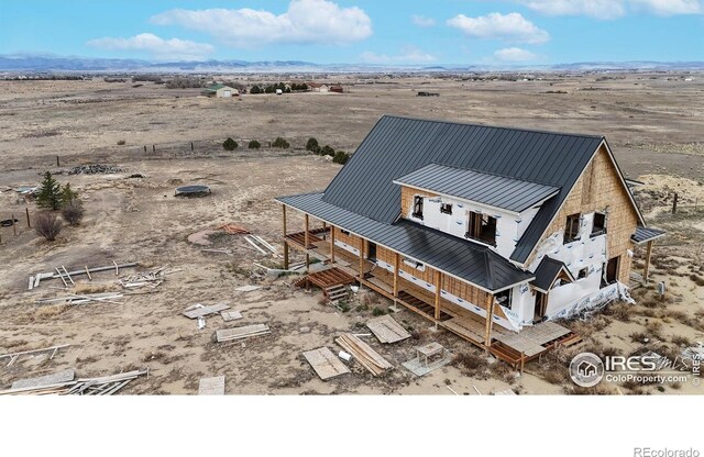 birds eye view of property with a rural view, a mountain view, and view of desert