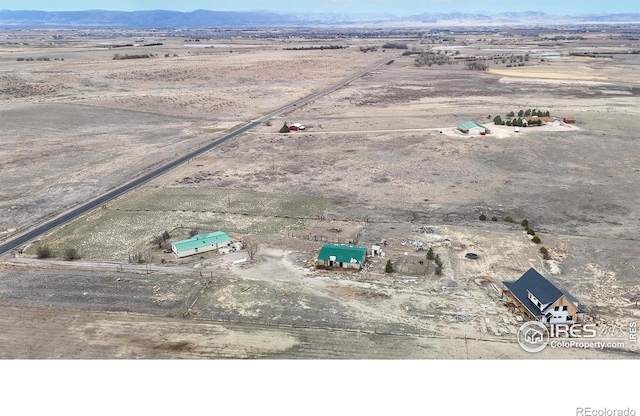 bird's eye view featuring view of desert, a mountain view, and a rural view