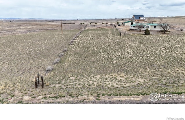 birds eye view of property with a rural view