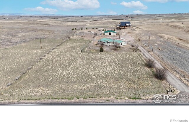birds eye view of property with a rural view