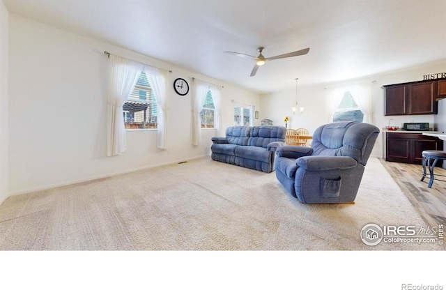 3712 Daylily St, Wellington, CO 80549 - living room featuring light carpet, baseboards, and a ceiling fan