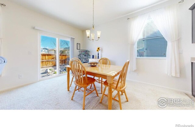 3712 Daylily St, Wellington, CO 80549 - dining area featuring light colored carpet and an inviting chandelier