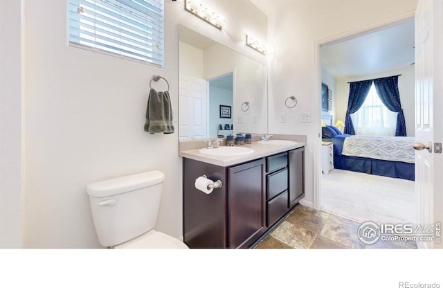 3712 Daylily St, Wellington, CO 80549 - bathroom featuring toilet, double vanity, a sink, and connected bathroom