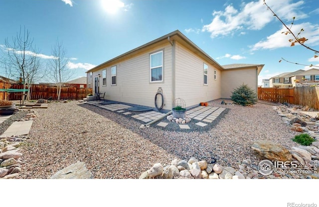 3712 Daylily St, Wellington, CO 80549 - rear view of house with a fenced backyard and a patio