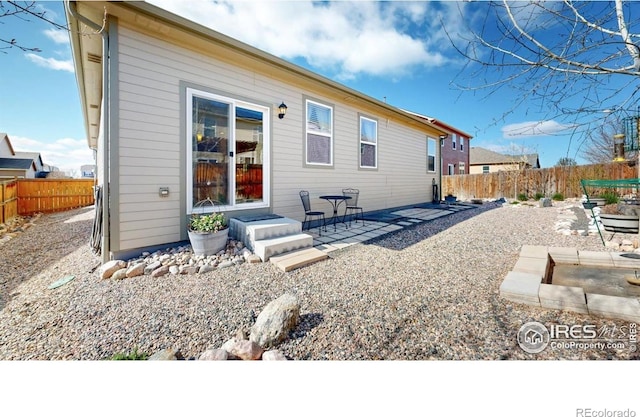 3712 Daylily St, Wellington, CO 80549 - rear view of house with a patio area and fence