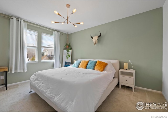 bedroom featuring baseboards, carpet flooring, and a chandelier