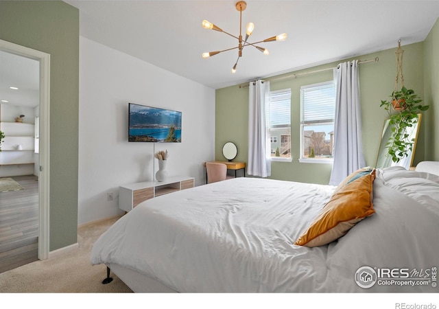 bedroom featuring a chandelier and carpet