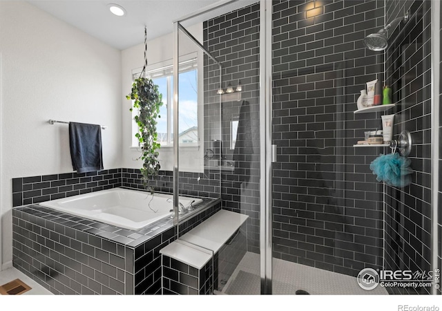 full bath featuring recessed lighting, a bath, and a stall shower